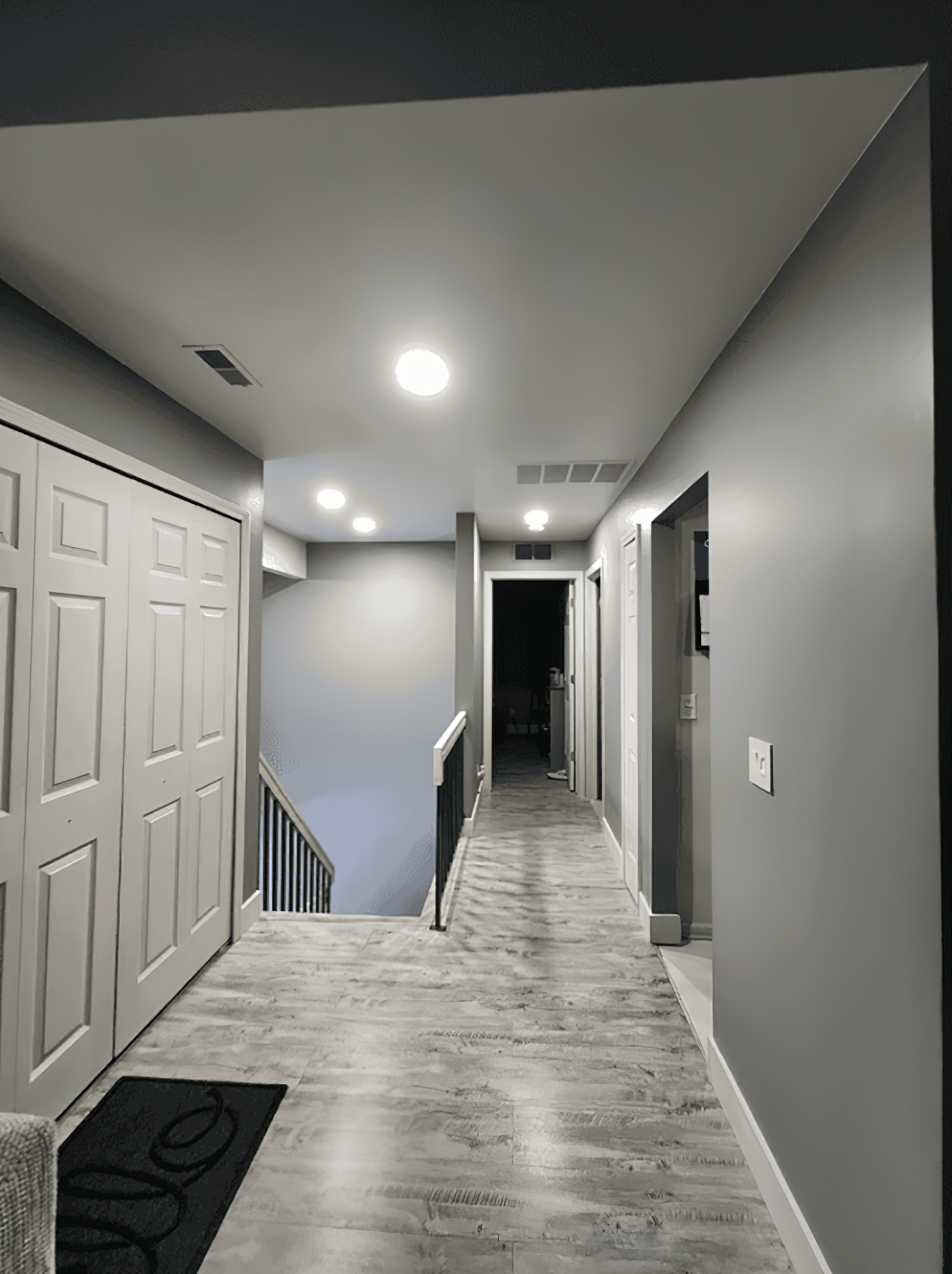 hallway painted with neutral gray with marble-like floor